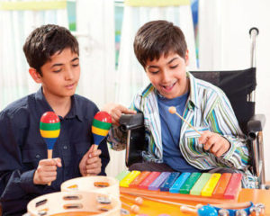 Boy in a wheelchair playing the xylophone